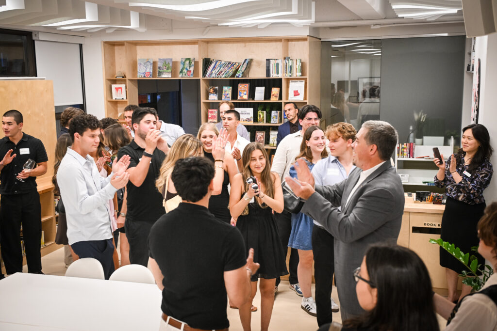 Class of 2020 alumni applaud in the Learning Commons at St. George’s during a reunion visit.