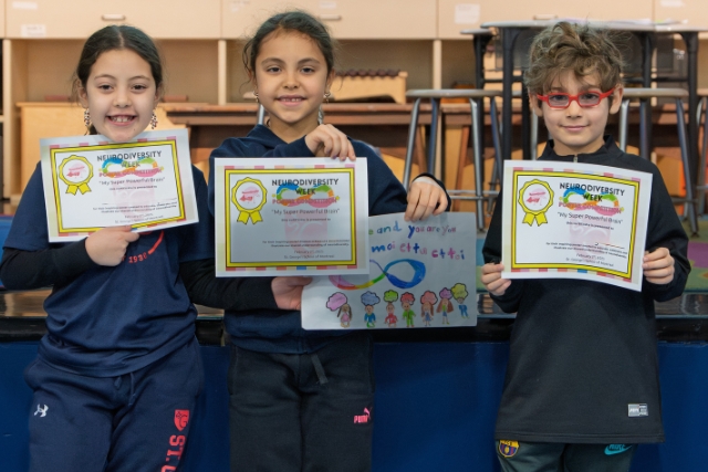 3 young students hold their certificates.