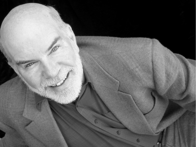 Head shot of an older bald man.