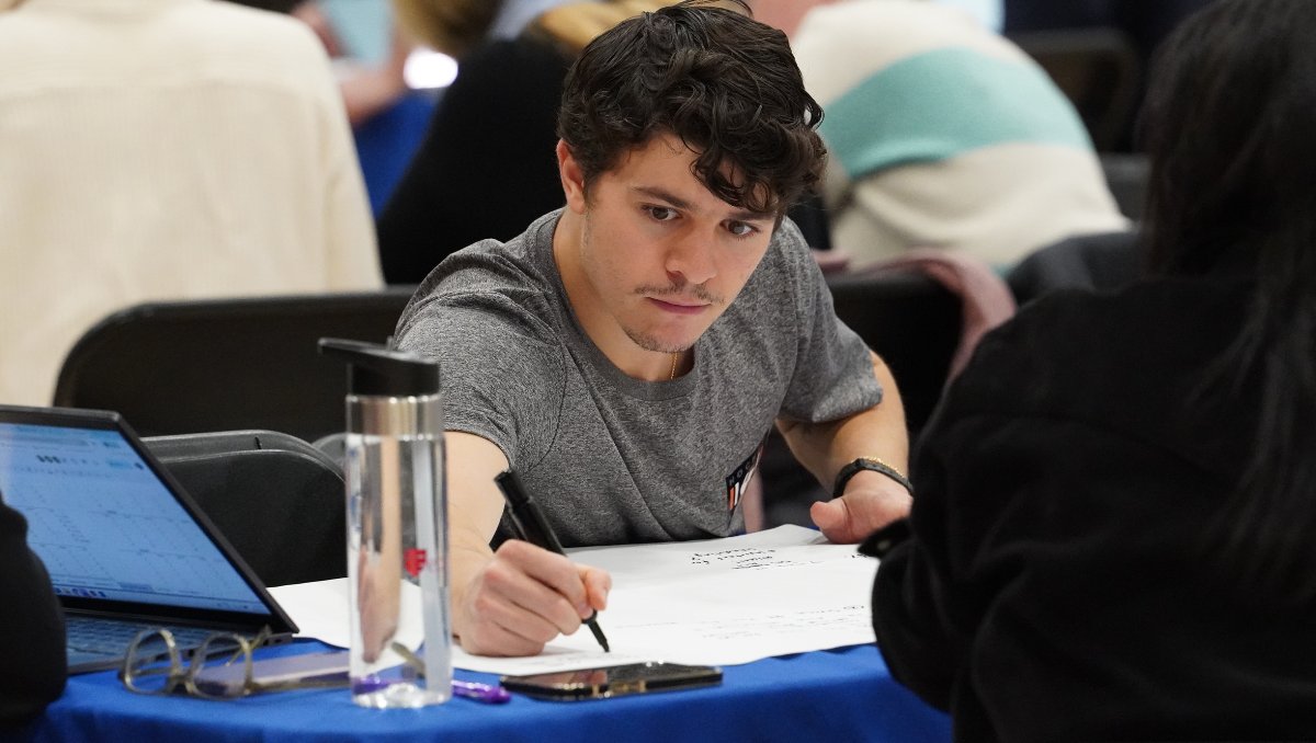 A young teacher works on data results.