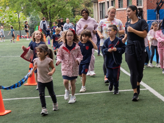 Students run on an athletic field